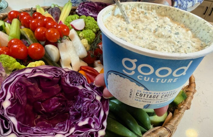 adding dip to a scooped out cabbage bowl