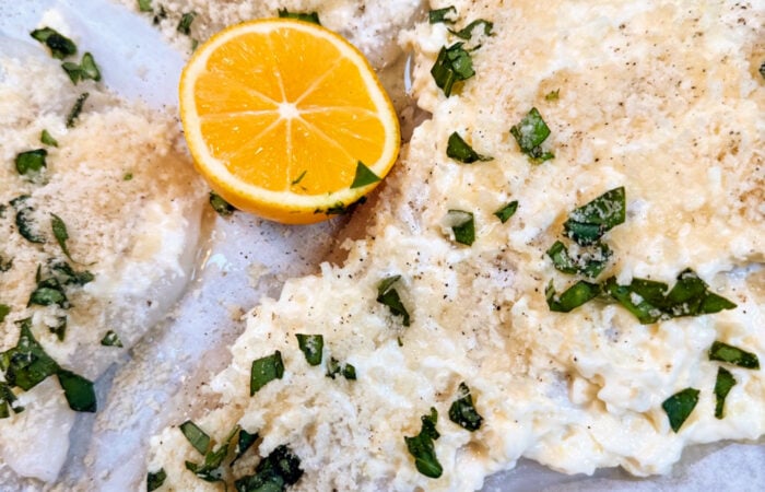 drizzling lemon on cod