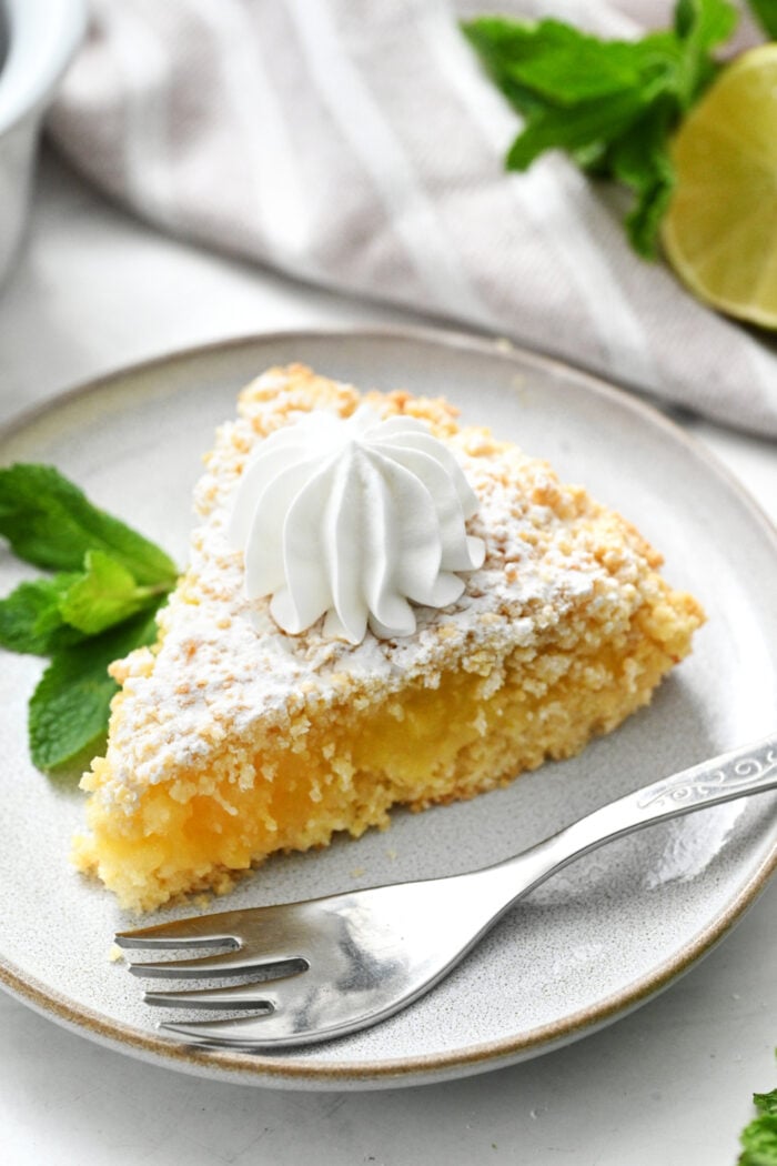 a piece of Lime Curd Cake with whipped cream