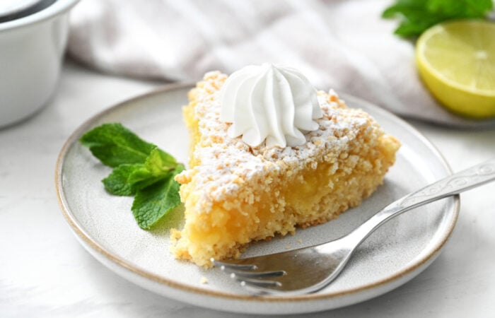 Lime Curd Cake with whipped cream and mint garnish