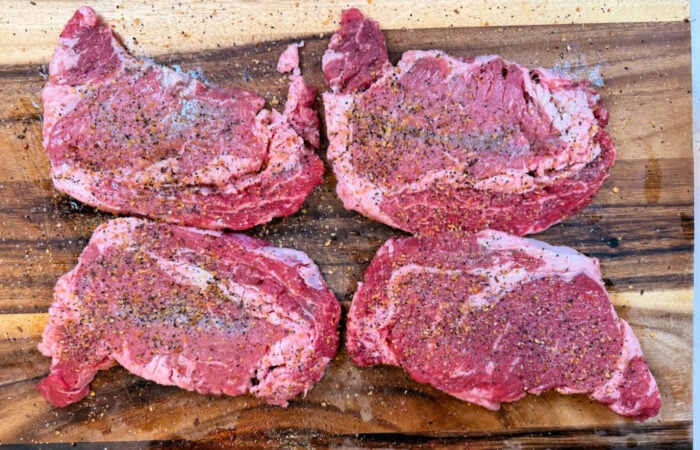 prepared ribeyes with seasoning