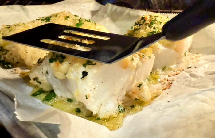 testing if fish is done with spatula