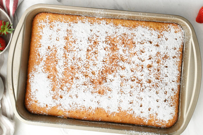 adding powdered sugar on cake