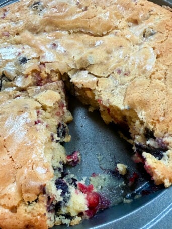 cutting into a round coffee cake