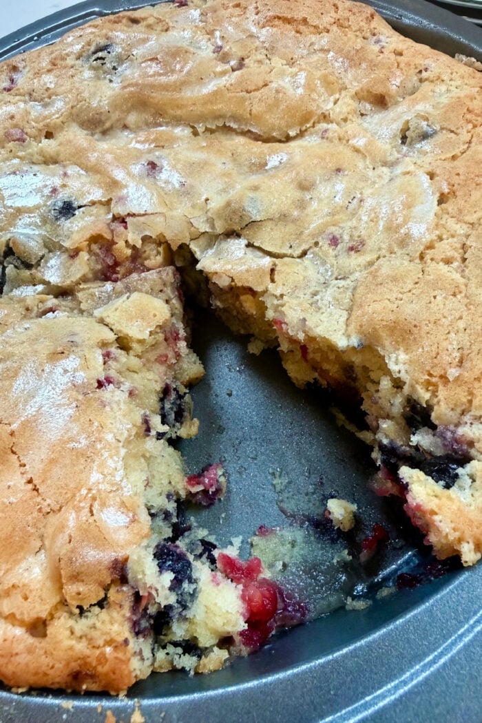 cutting into a round coffee cake