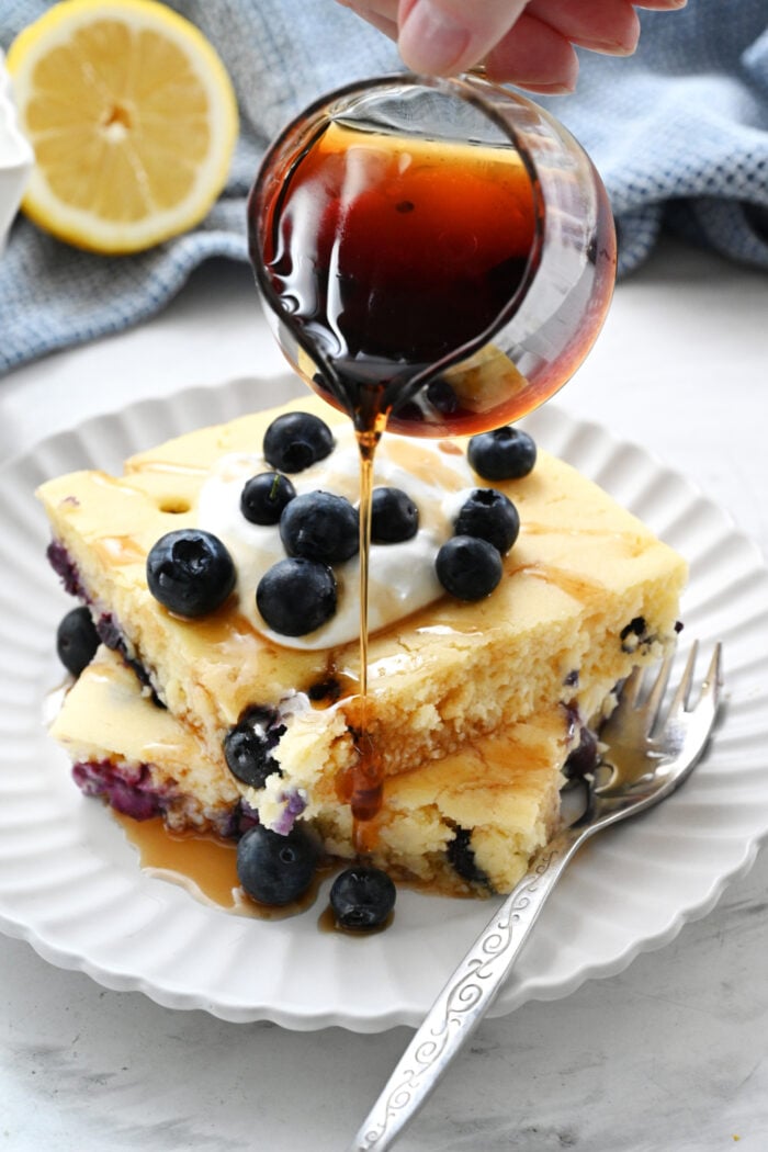 pouring syrup on pancakes