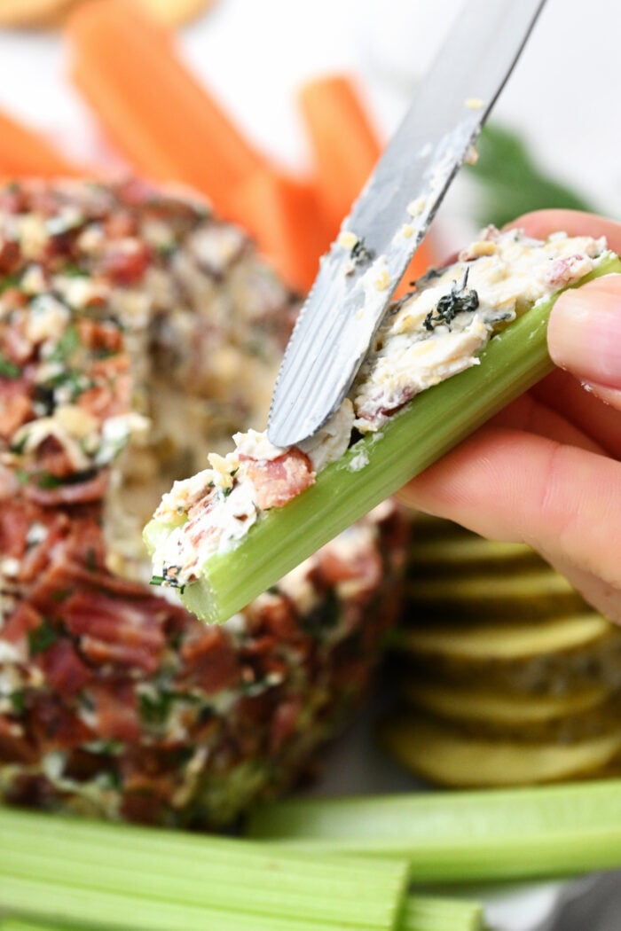 spreading cheese on celery