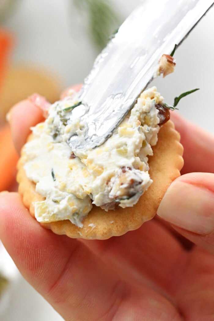 spreading cheese on Ritz cracker