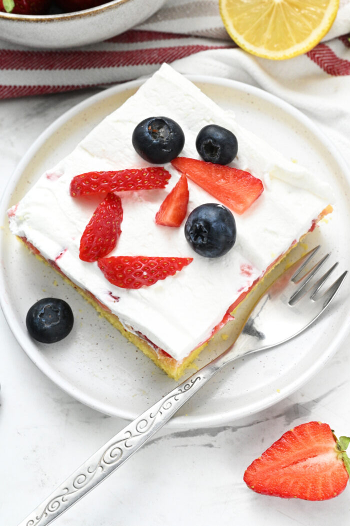 a piece of Easy Strawberry Shortcake Sheet Cake with berries