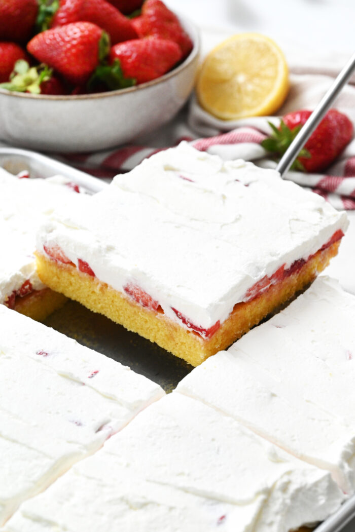 serving a piece of Easy Strawberry Shortcake Cake