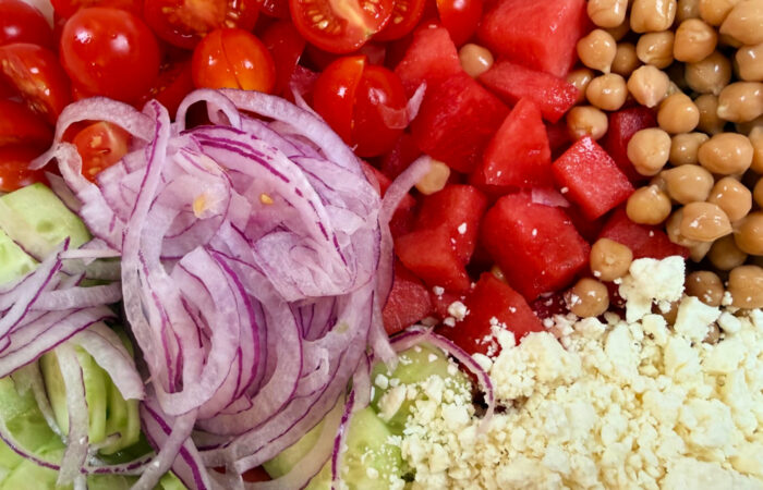 adding onion to summer salad