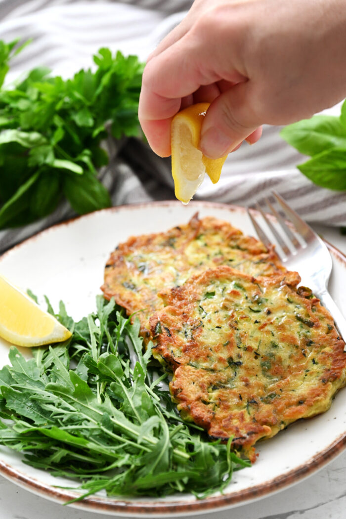 squeezing lemon on Fritters