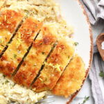 serving sliced crispy chicken with orzo