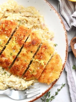 serving sliced crispy chicken with orzo