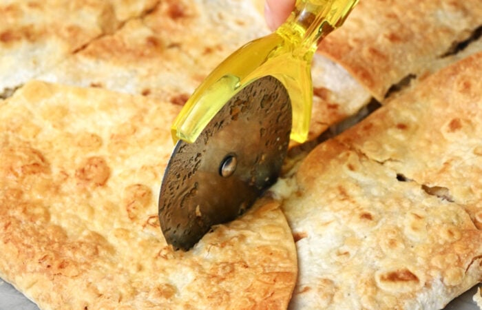 cutting a baked quesadilla